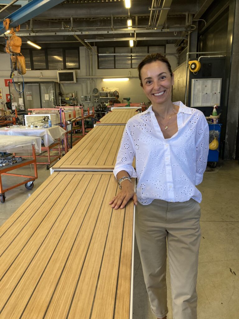 dressed in white shirt, Fiorella Besenzoni stands next to gangway