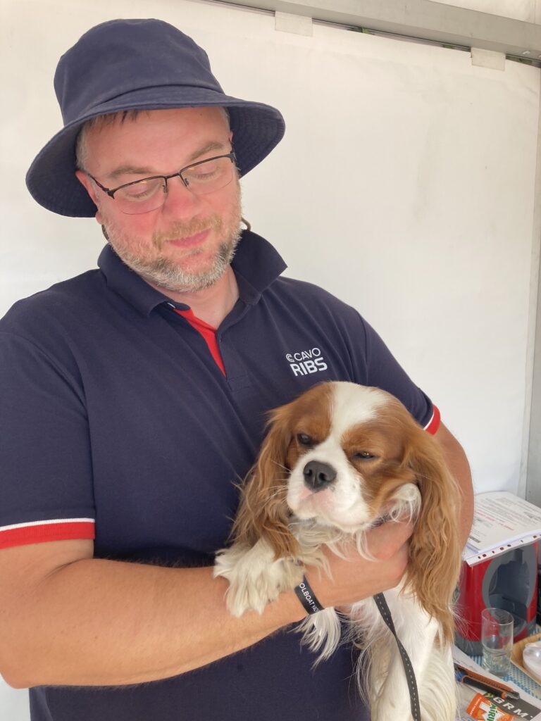 Jakub Dec Cavo Marine holds his dog 