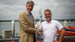 two men shaking hands on the Savvynavvy and RNLI partnership