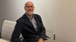 Marco Dona SAIM sits behind desk in an office