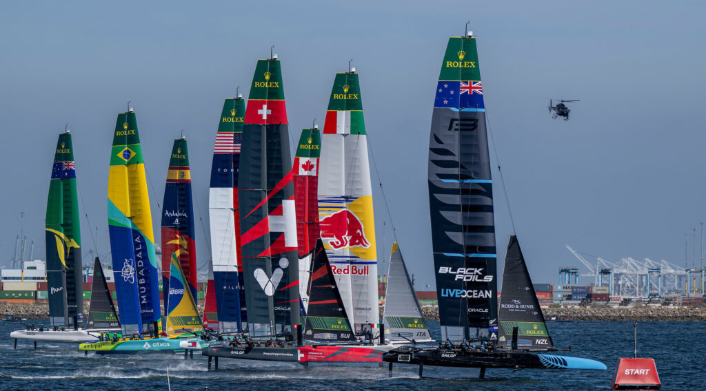 New Zealand SailGP Team helmed by Peter Burling lead over Red Bull Italy SailGP Team helmed by Ruggero Tita, Switzerland SailGP Team helmed by Sebastien Schneiter and the rest of the the SailGP feet on Race Day 1 of the Rolex Los Angeles Sail Grand Prix held in the Port of Los Angeles, California, USA. Saturday 15 March 2025. Rolex SailGP Championship Event 4 Season 2025. Photo: Jason Ludlow for SailGP. Handout image supplied by SailGP