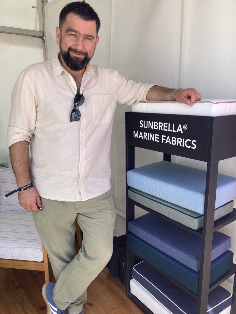 Sunbrella Tomasz Stefamec leans on product display