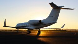 private jet on tarmac at sunset