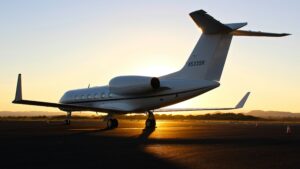 private jet on tarmac at sunset