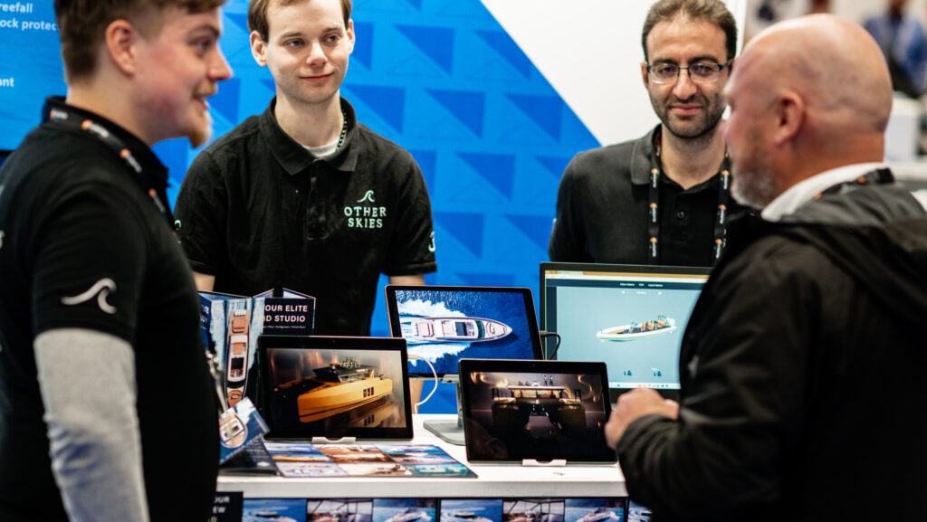 Four men look at displays in Metstrade startup area