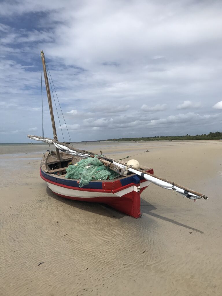 red fishing vessel on vast sands in Mozambique