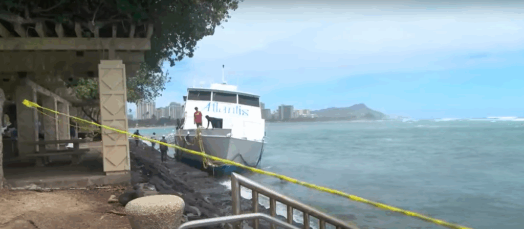 bow view of ferry stuck against wall in Honolulu after it was caught in high surf