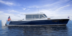MJM 47X side view dark blue hull white roof. This is one of MJM Yachts' vessels. From 2026, all models will be offered with Seakeeper gyro stabiliser