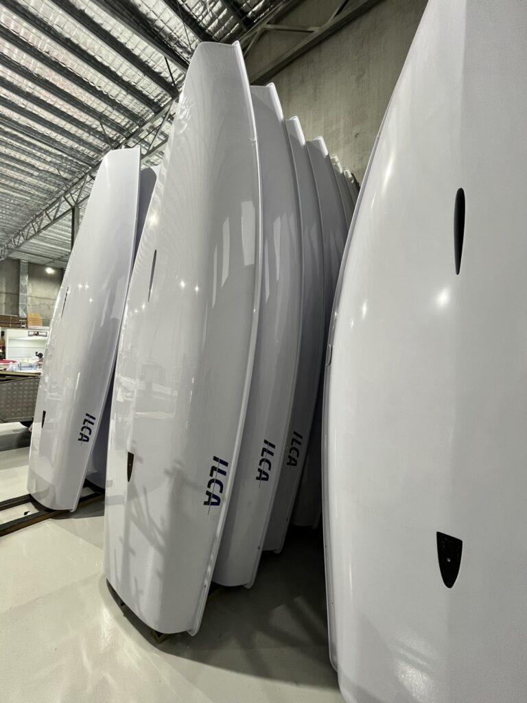 ILCA being made in Performance Marine Group premises Australia - hulls stacked on wall