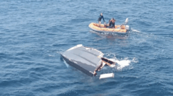 Image of semi submerged boat wreckage and dinghy