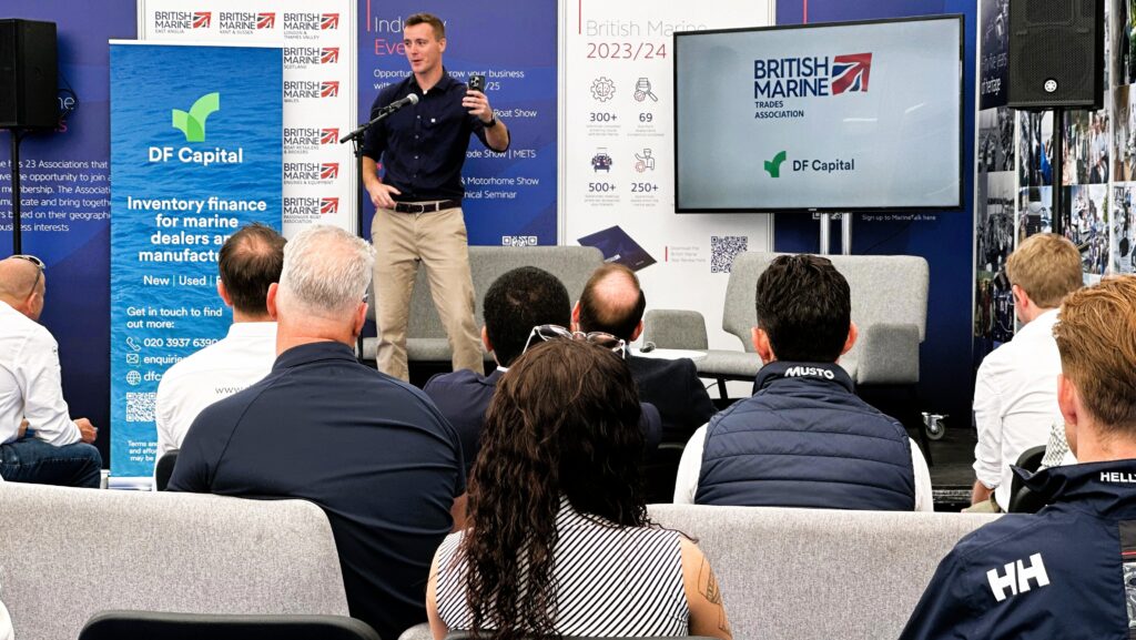 a man leading a panel discussion at southampton boat show