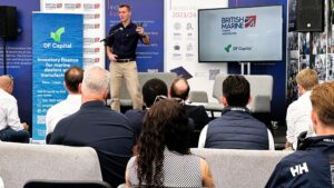 a man leading a panel discussion at southampton boat show