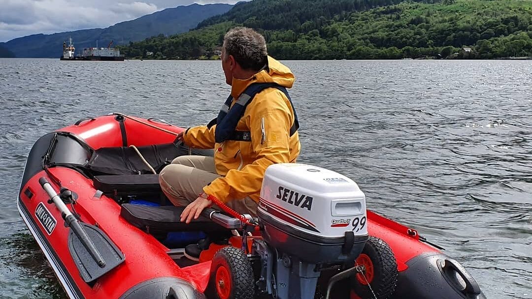 image of man in dingy with selva outboard engine