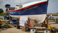 Image of guide of blue and white hulled boat - the dunkirk boat being restored