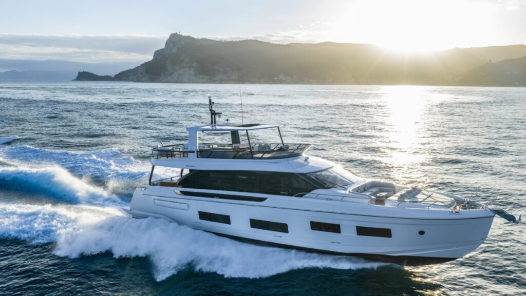 82-foot white flybridge motor yacht cruising at sea