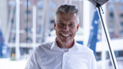 Man smiling in white shirt