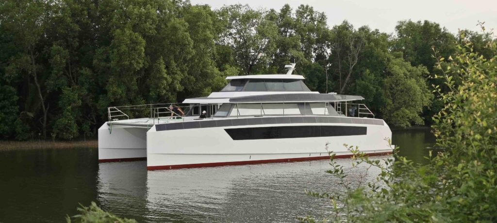 Large white luxury catamaran on a river