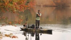 A man and a dog fishing on a Hobie vessel