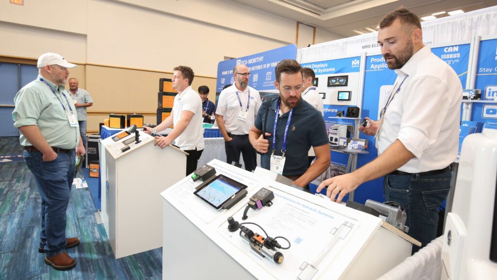 Men look at equipment at IBEX