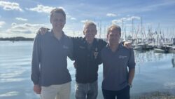 Photo of 2 men in front of boats at marina