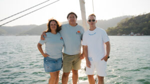 Image of two men and one woman from BOATSCRIBE and EOS Yacht Charter on a sailboat