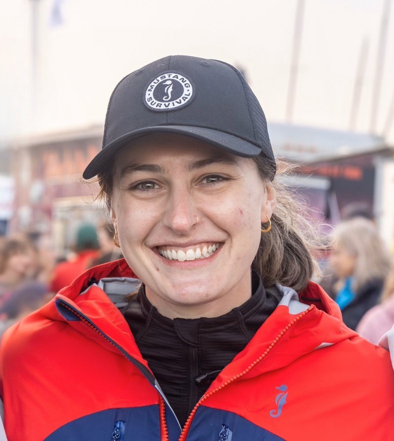 girl in sailing jacket and cap smiling 