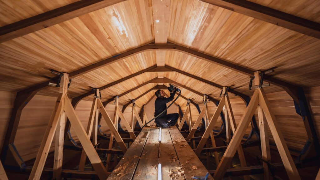 boatbuilder working on hull