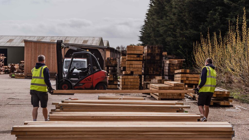 Spirit Yachts' yard with men moving wood
