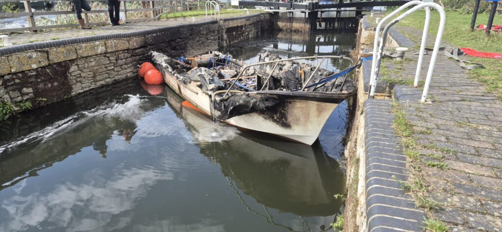 An image of the remains of a burnt boat at Kelston lock