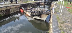 An image of the remains of a burnt boat at Kelston lock