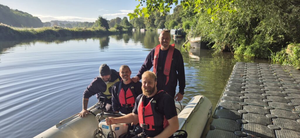 An image of recovery team of four men in boat at Kelston Lock