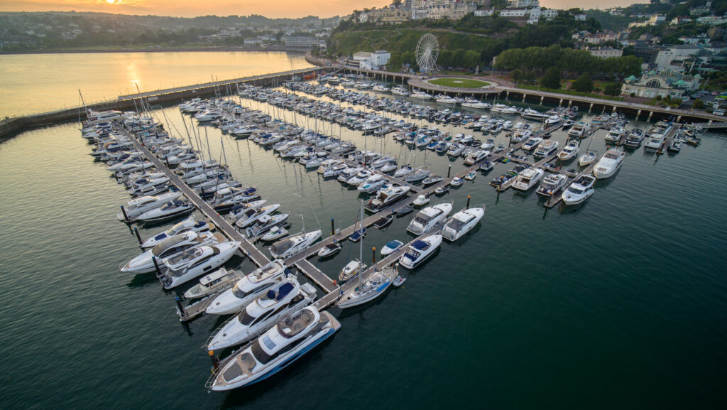 bird's eye view of Torquay marina full of boats at sunrise
