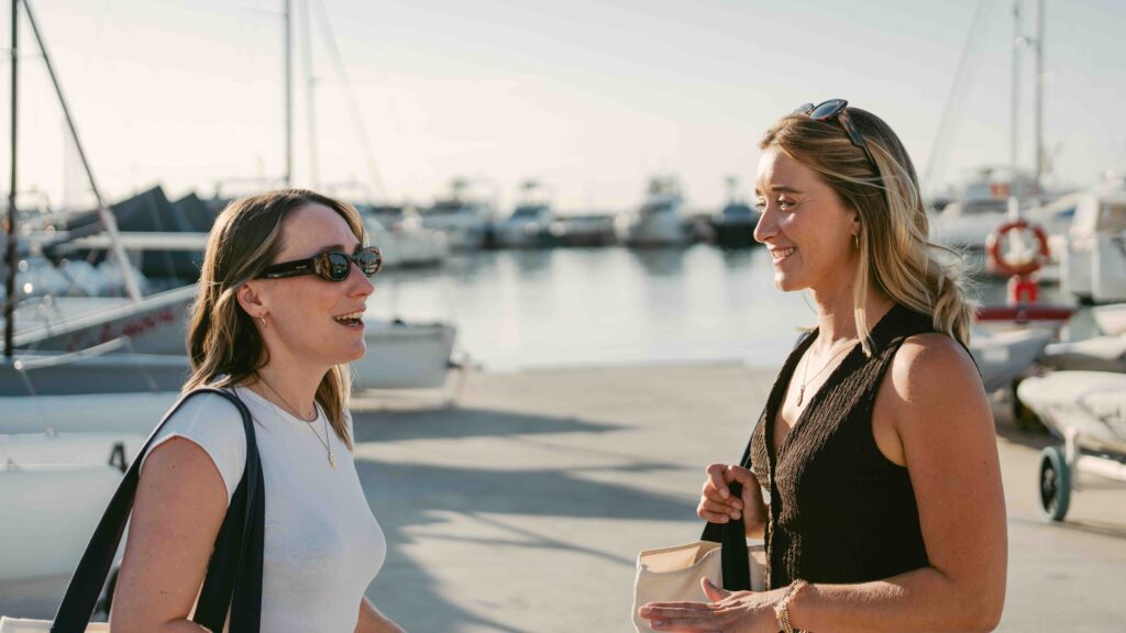 Two women by a marina