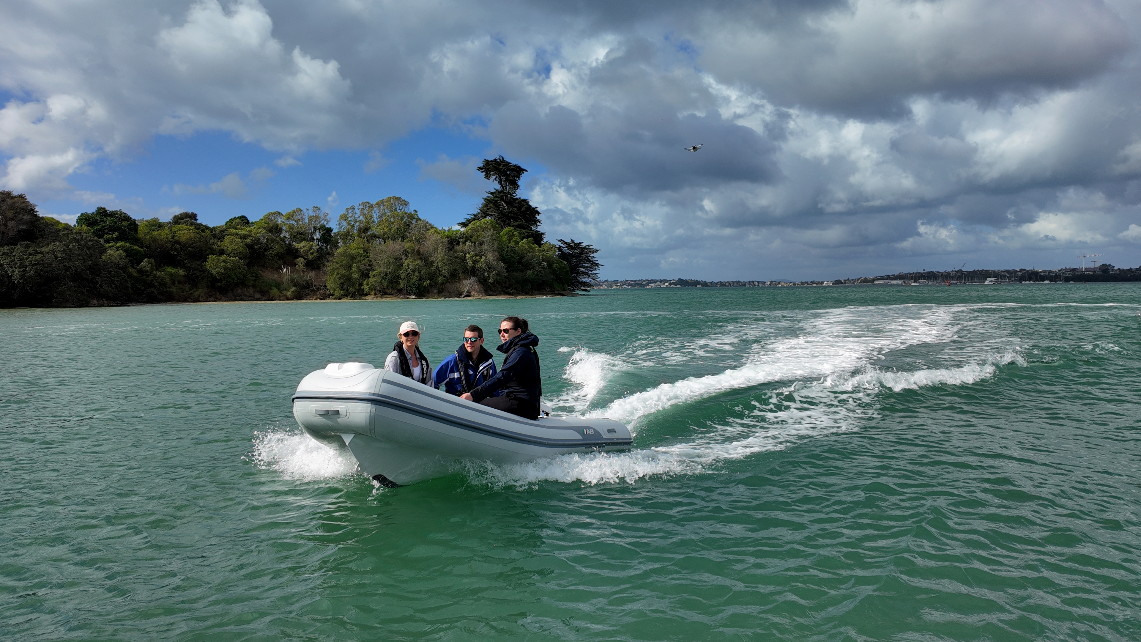 image of inflatable rib with three people in cruising