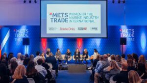 image of event conference with a panel of speakers and audience