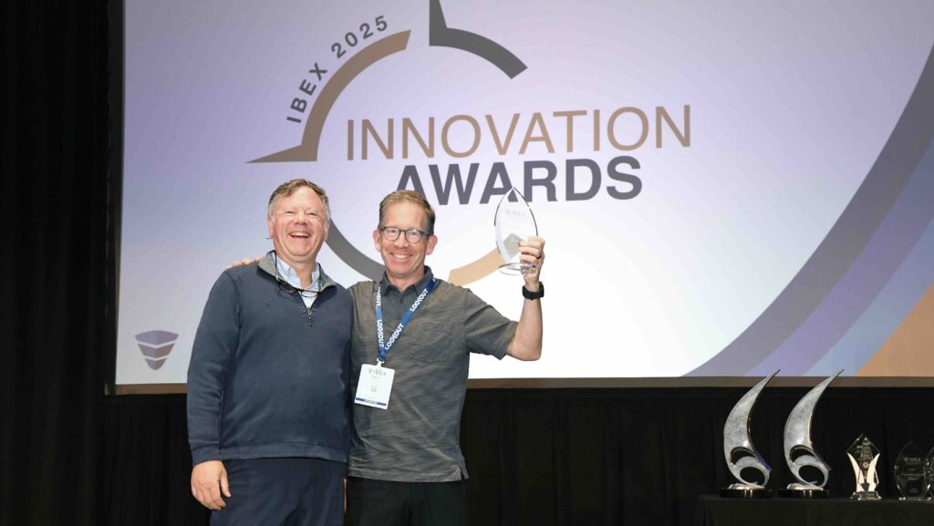 Two men collecting a NMMA innovation award