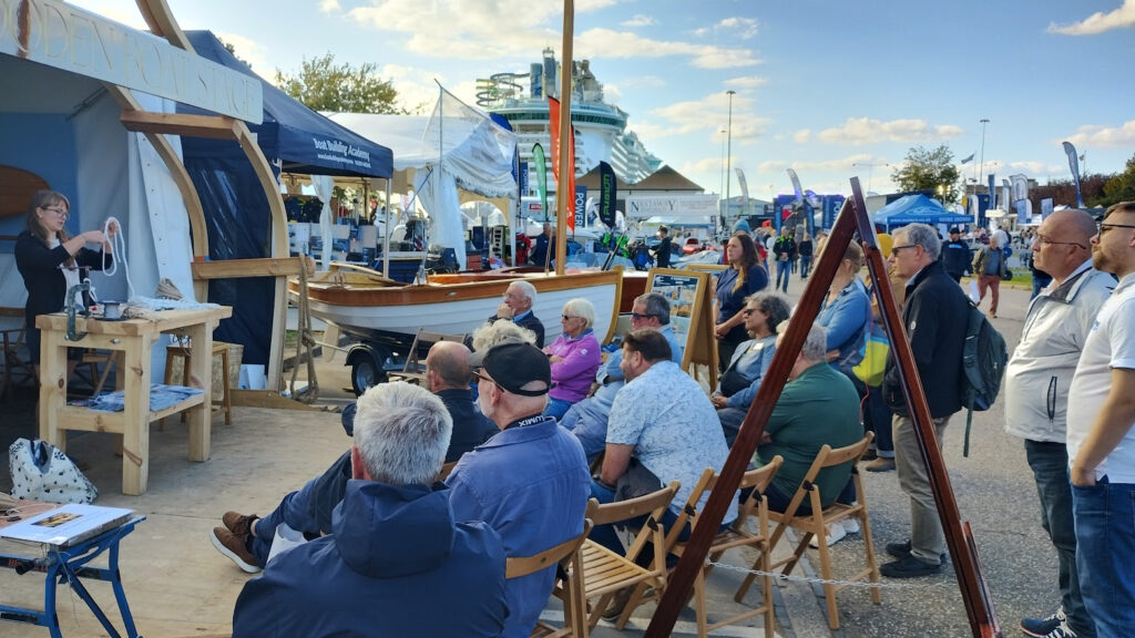 crowds at SIBS' Wooden Boat Stage sit to watch demonstration.