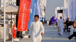 man strides down pontoon at boat show