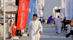 man strides down pontoon at boat show