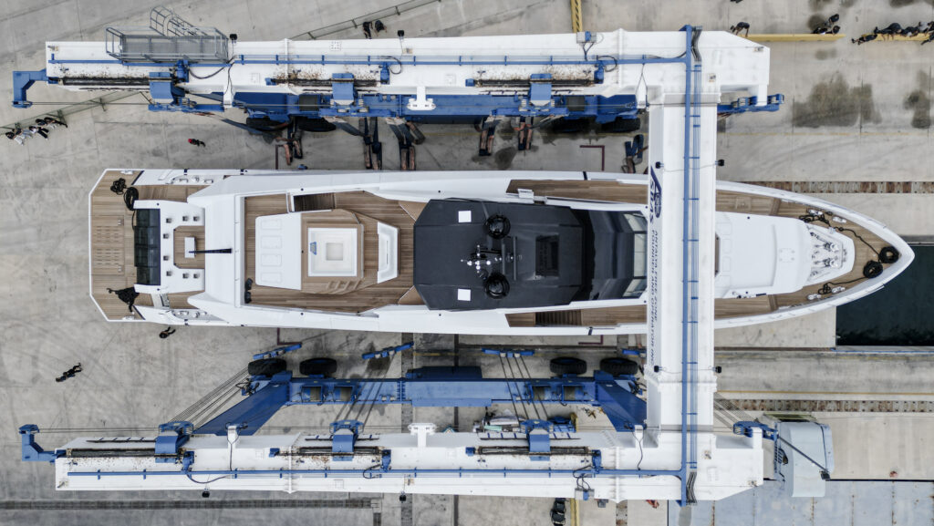 Birds eye view of white motor yacht with teak deck