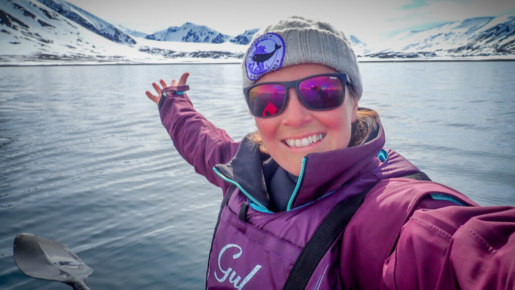 Katherine Knight poses against mountains and water