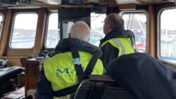 Two MAIB investigators look out of a boat window