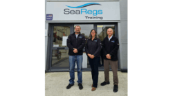 three people stand outside SeaRegs office building