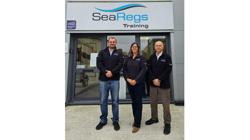 three people stand outside SeaRegs office building