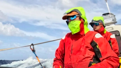 Jess Rowe and Miriam Payne in wet weather gear as they row the Pacific