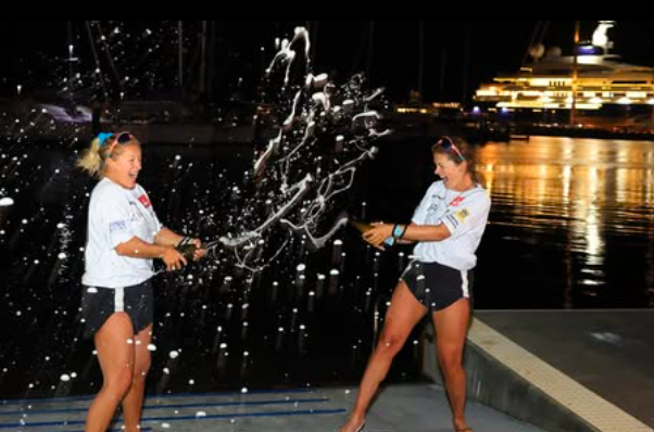 Jess Rowe and Miriam Payne celebrate with fizz after stepping ashore in Australia