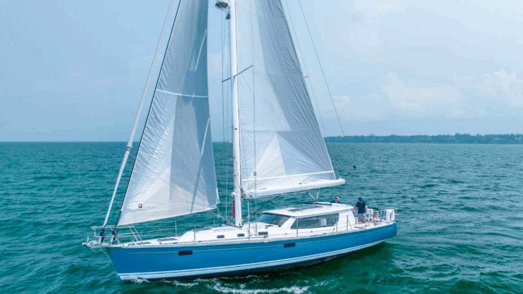 A Tartan 455 with blue hull under full sail