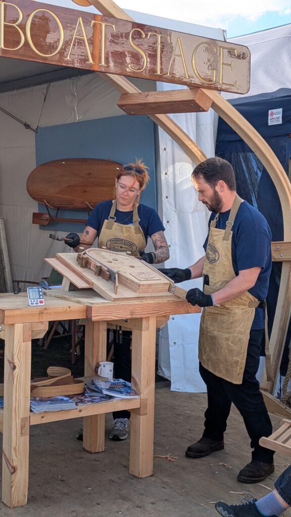 two boatbuilders give demo on steaming wood to shape for boatbuilding as skills in industry under threat