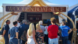 a crowd gathers at the Wooden Boat Stage at SIBS