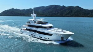 Side view image of white superyacht cruising